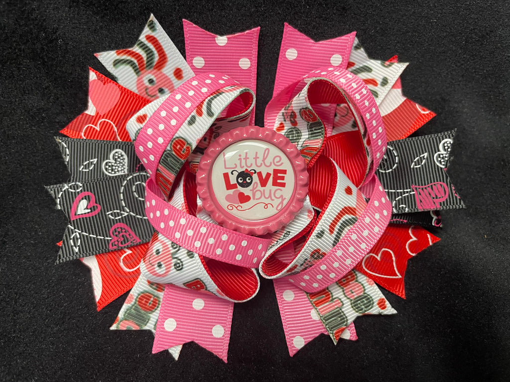LAYERED MULTI COLOR AND VARIOUS STYLE RIBBONS BOW WITH LITTLE LOVE BUG BOTTLE CAP CENTER (Roughly 5” in length) - Lil Monkey Boutique
