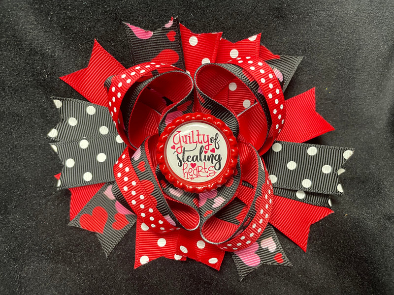 LAYERED MULTI COLOR AND VARIOUS STYLE RIBBONS BOW WITH GUILTY OF STEALING HEARTS BOTTLE CAP CENTER (Roughly 5” in length) - Lil Monkey Boutique